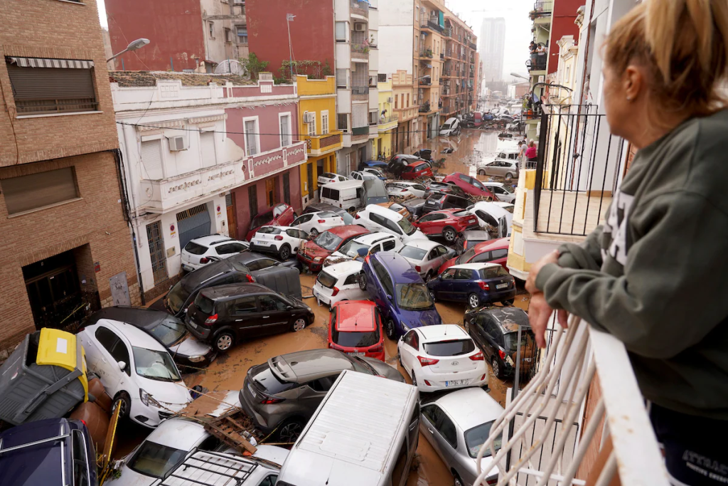 Spain flooding as vehicles are piled in the streets of Valencia on Wednesday. (Image Credit: Alberto Saiz/AP)
