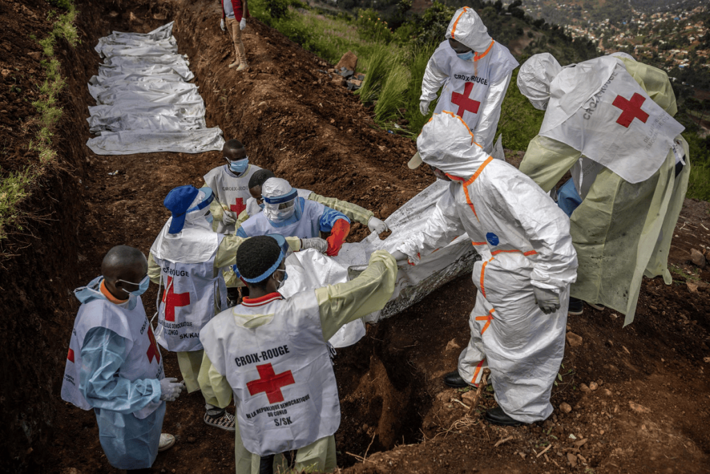 Members of the Congolese Red Cross carry body bags containing human remains during a mass burial for victims, Feb. 20, 2025. (Image Credit: AFP Photo)