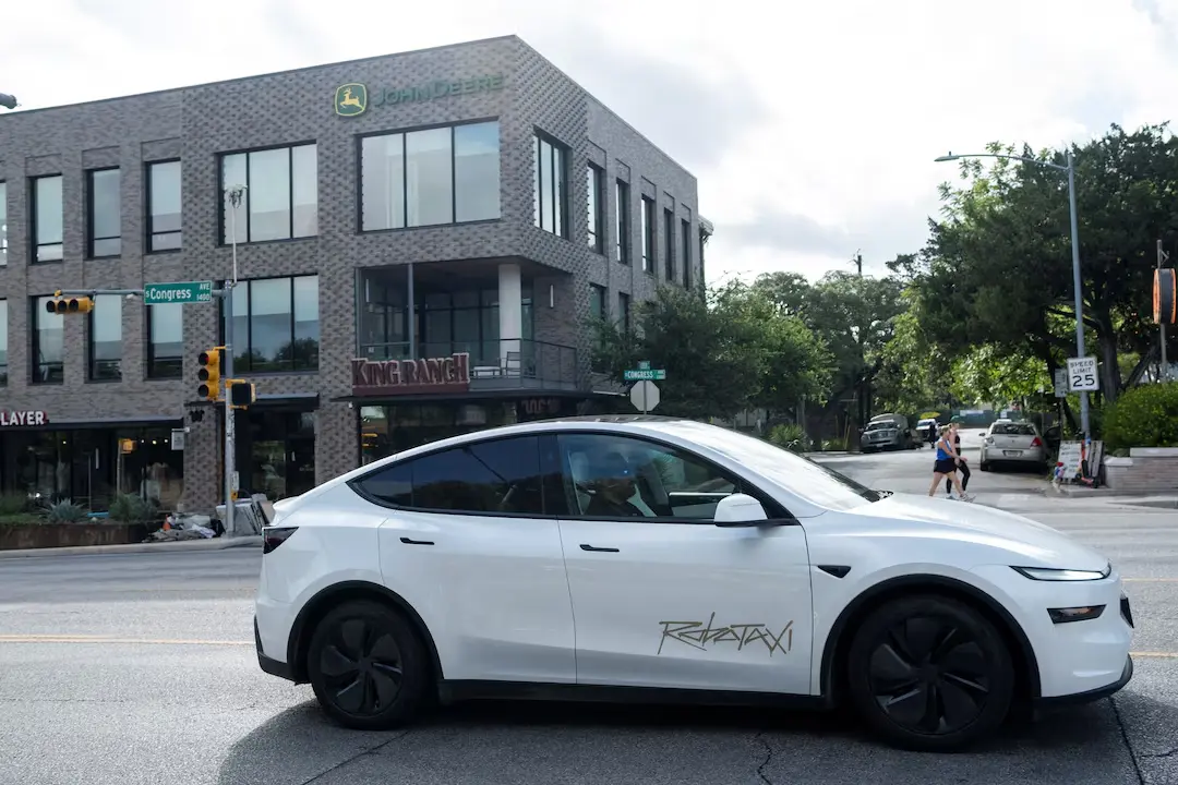 A Tesla robotaxi drives on the street along South Congress Avenue in Austin, Texas, U.S., June 22, 2025. (Image Credit: REUTERS/Joel Angel Juarez)