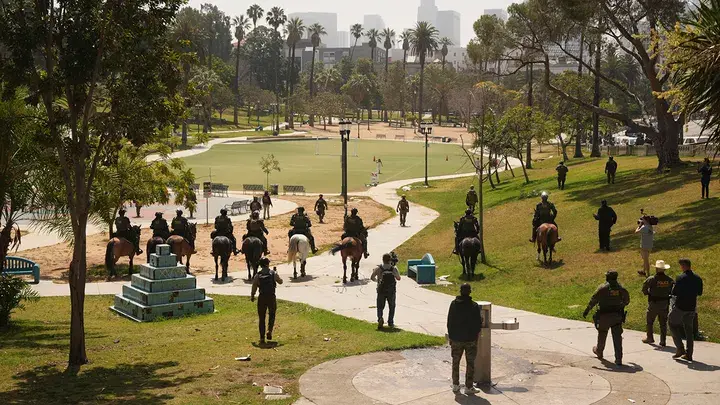 ICE federal agent at MacArthur Park, on Monday in Los Angeles. (Image Credit: Damian Dovarganes/AP)