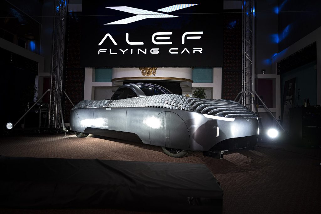 Alef Aeronautics flying car soaring over a Tesla Roadster