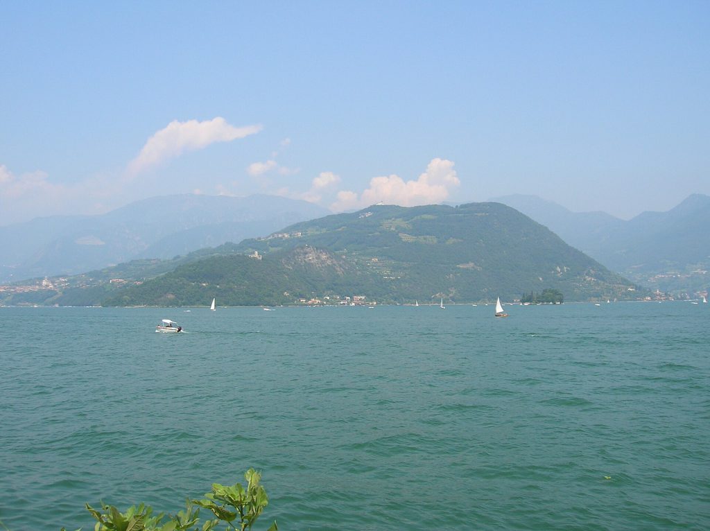 Cycling Monte Isola: Italy’s Car-Free Lake Iseo Island Cyclists riding on a car-free road along the shore of Monte Isola in Lake Iseo