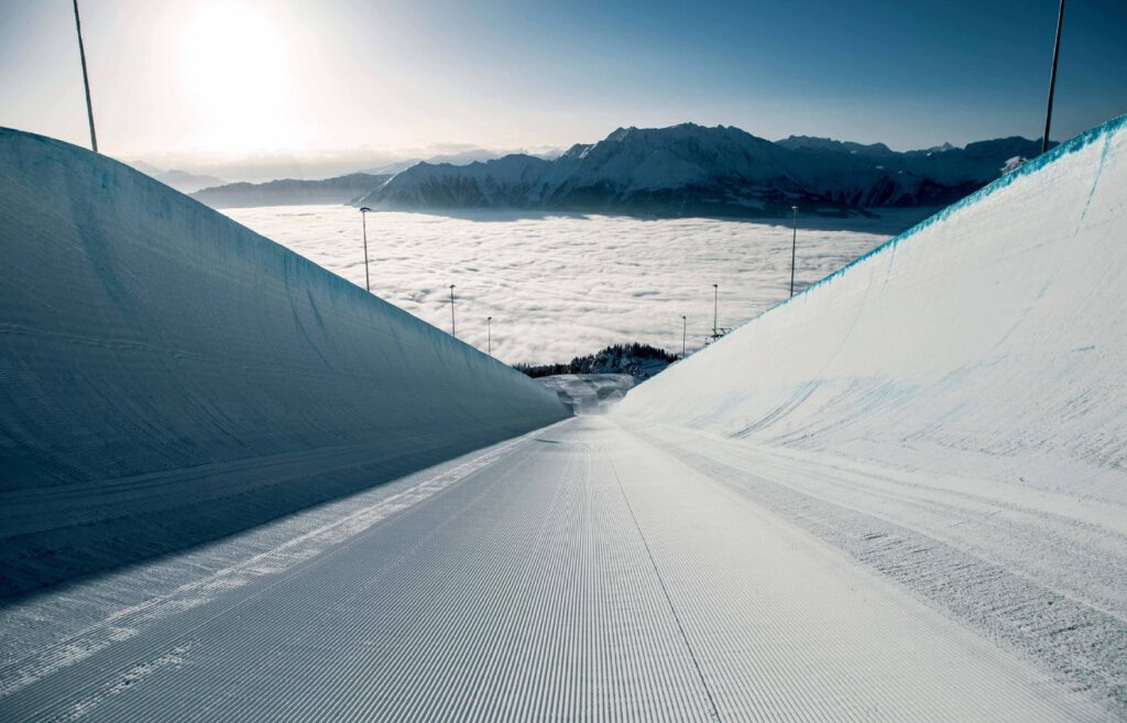 Laax Ski Resort Targets Carbon Neutrality by 2030 Ski slopes at Laax ski resort with snow cannons and electric grooming equipment