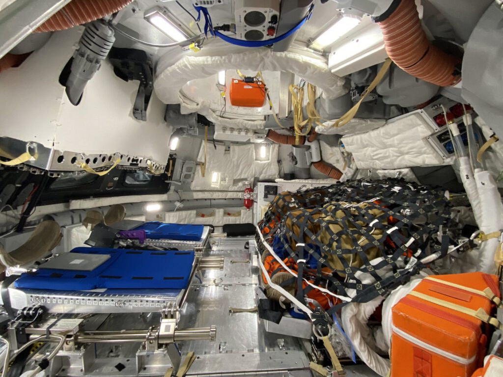 SpaceX Starship lunar lander docking with Orion spacecraft in high-Earth orbit