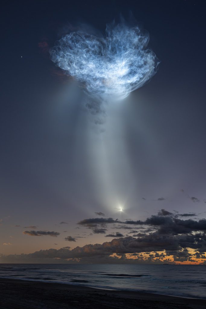 SpaceX CRS-35 Falcon 9 rocket exhaust plume creating a jellyfish shape at sunrise