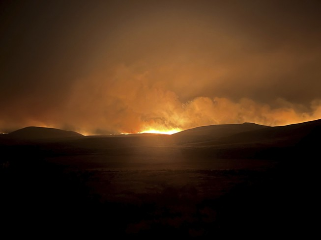 In this photo provided by the Oregon Department of Transportation, the Durkee Fire lights up the sky in eastern Ore., Monday, July 22, 2024.