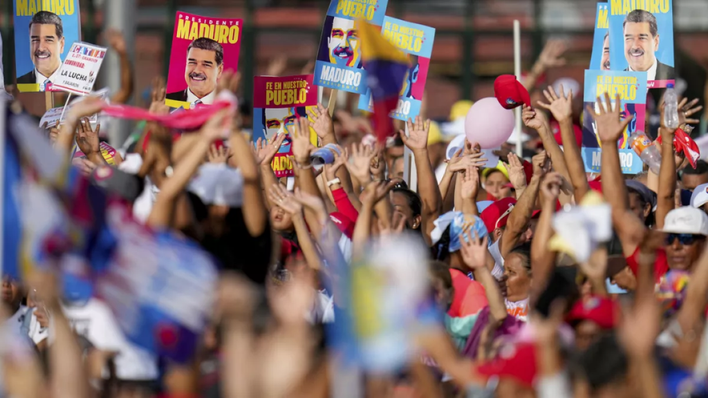 Supporters display posters of President Nicolas Maduro during his closing election campaign rally in Caracas, Venezuela, Thursday, July 25, 2024. Maduro is seeking re-election for a third term in the July 28 vote. (Credit: Fernando Vergara / ASSOCIATED PRESS)