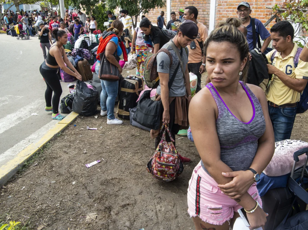 Venezuelan migrants arrive to obtain an asylum application at the Peruvian border post at the binational border service center (CEBAF) in Tumbes, Peru. (Credit: AFP/Getty Images)