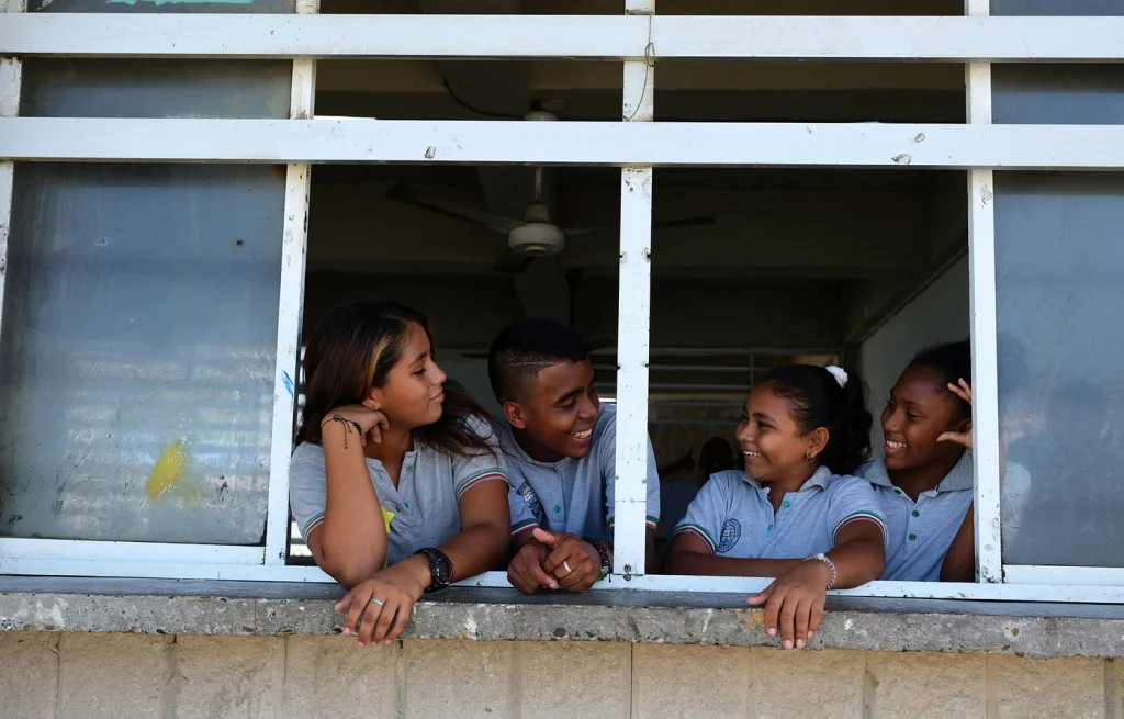 From left to right, at the Tierra Bomba school, Chelsea (14), Adriana (14), Bryan (16), and Mariangelis (13) represent diversity and inclusion, as they are internally displaced people, host community members, as well as Venezuelan refugees and migrants. (Source: United Nations High Commissioner for Refugees / UNHCR)