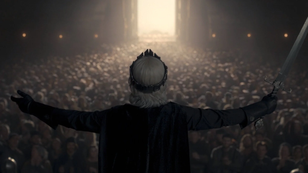 Aegon is anointed by Septon Eustace and crowned by Criston Cole with his ancestor Aegon the Conqueror's crown as King Aegon II, usurping Rhaenyra. (Credit: HBO)