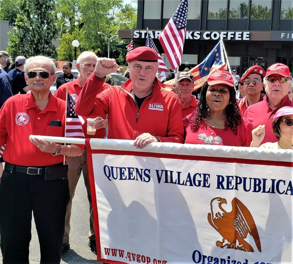 New York Woman Sues Mets for $2 Million After Being Barred From Wearing MAGA Hat at Citi Field 2 Aura Moody (right) is a member of the Queens Village Republican Club. She is pictured here with Curtis Sliwa. Facebook/Queens Village Republican Club, Inc.