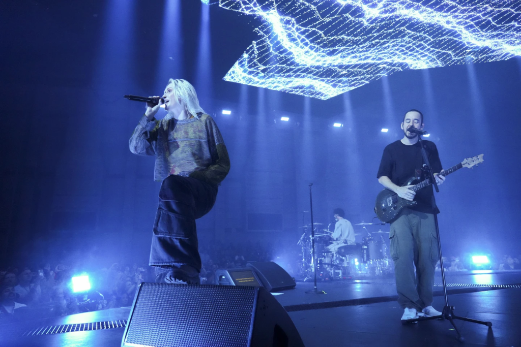 Linkin Park Welcomes Emily Armstrong as New Lead Singer 1 From left to right, Emily Armstrong, Colin Brittain (the drummer), and Mike Shinoda (co-vocalist) of Linkin Park performs Thursday, Sept. 5, 2024, in Los Angeles. (Image Credit: Jordan Strauss / Invision / AP)
