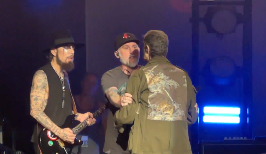 Jane's Addiction Reunion Concert Ends In Chaos As Perry Farrell And Dave Navarro Clash 2 A crew member ran on stage, separating the Perry Farrell and Dave Navarro before things turned more violent. (Image Credit: YouTube / Associated Press)