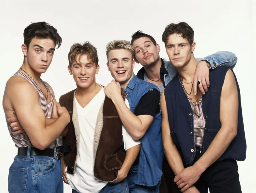 Robbie Williams is seen here in 1992 with his Take That bandmates Mark Owen, Gary Barlow, Jason Orange, and Howard Donald. (Credit: Tim Roney / Getty Images)