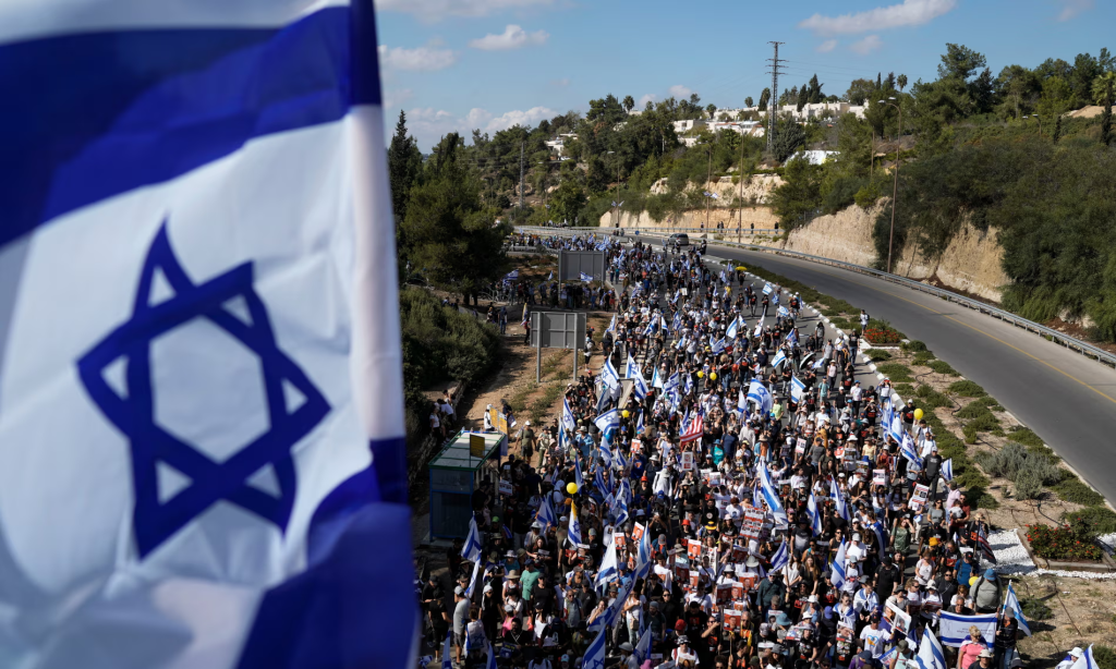 Protesters demanding the hostages’ return on a five-day march from Tel Aviv to in Jerusalem in November 2023 after the 7 October attack on Israel. (Image Credit:: Léo Corrêa/AP)