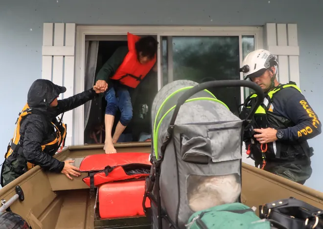 Hurricane Milton Damage: Death Toll Rises and FEMA Aid on the Horizon 3 Volusia County Fire Rescue team members rescue residents on Magnolia Avenue in South Daytona after Hurricane Milton flooded the area, as death toll Hurricane Milton rises. (Image Source: Nadia Zomorodian/NewsJournal)