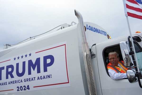 Former President Donald Trump in garbage truck as he talks to reporters Wednesday, Oct. 30, 2024, in Green Bay, Wis.  (Image Credit: Julia Demaree Nikhinson / AP)