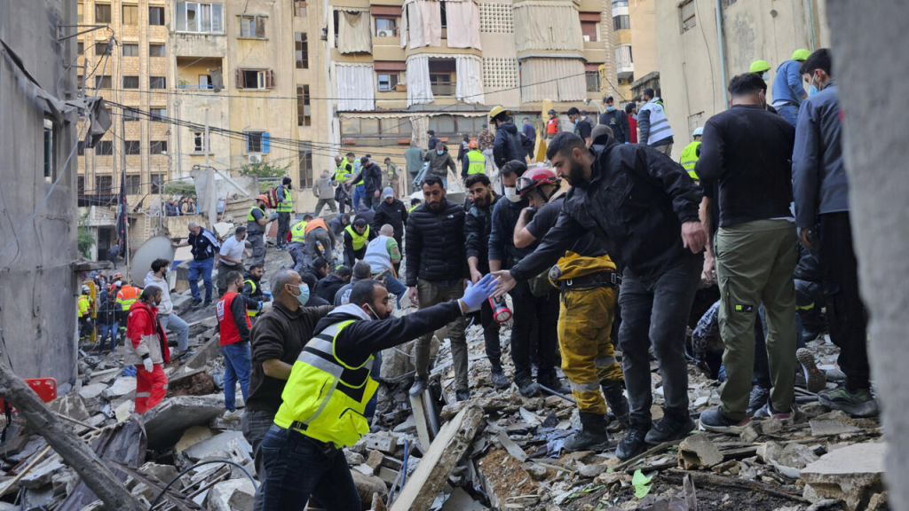 Ceasefire Between Israel and Hezbollah: A Step Towards Peace 1 Rescuers search for victims at the site of an Israeli airstrike in Beirut on November 26, 2024, before the Hezbollah ceasefire agreement was reached. (Credit: Hassan Ammar / AP)