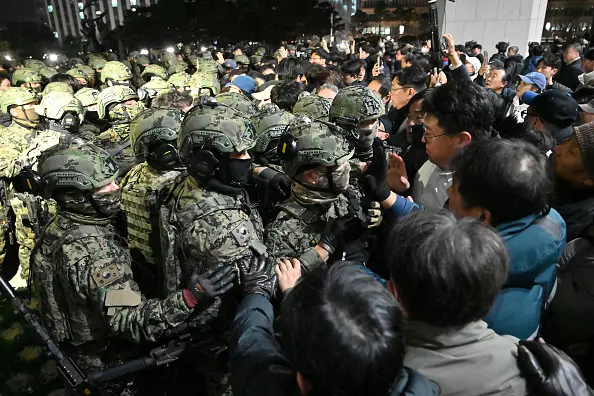 Why Did South Korea Martial Law Was Suddenly Declared? 2 Chaos in Seoul as soldiers clash with protesters of South Korea martial law when they tried to enter the National Assembly building in the capital. (Credit: Getty Images)