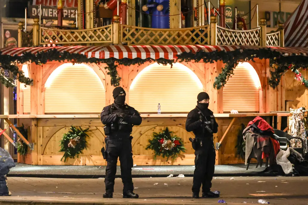 Tragedy at Magdeburg Christmas Market Attack: What We Know 1 Police officers around the scene of the Magdeburg, Germany Christmas market. (Image Credit: FILIP SINGER / Shutterstock)
