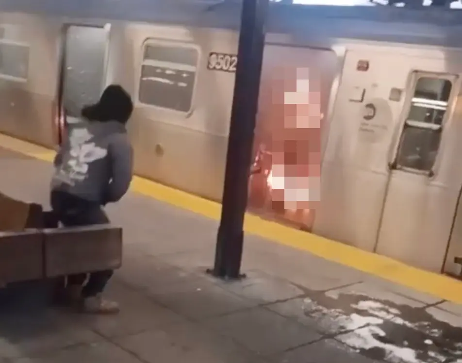 Illegal Immigrant Set New York Woman on Fire: What We Know 1 Surveillance footage of the suspect watching the woman burning in New York. (Image Credit: NYPD)