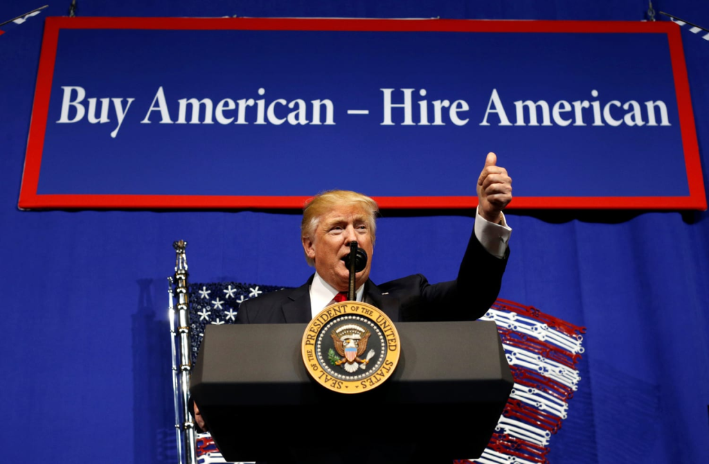 Trump’s Second Term: What It Means for the H-1B Visa Program 1 President Donald Trump speaks before signing an executive order in his first term, directing federal agencies to recommend changes in the H-1B visa program on April 18, 2017. (Image Credit: Kevin Lamarque / Reuters)