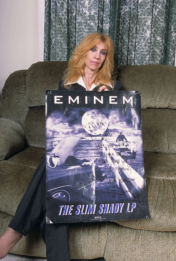Eminem mom, Debbie Nelson, holds a poster with a hand written message during a portrait session at her home in September, 2005 in Detroit, Michigan. (Credit: Mark Weiss/Getty Images)