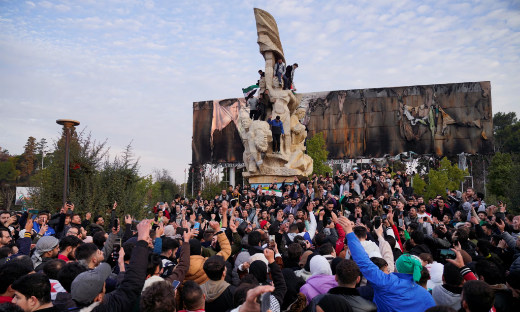 People gather at Saadallah al-Jabiri Square as they celebrate, Assad plane shot down marked a new chapter for the country of Syria. (Image Source: Karam al-Masri / Reuters)