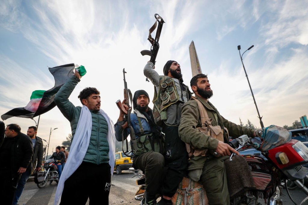 Syrian rebel fighters celebrate after declaring the Syrian capital of Damascus "liberated" on December 8. (Image Credit: Omar Sanadiki / AP)