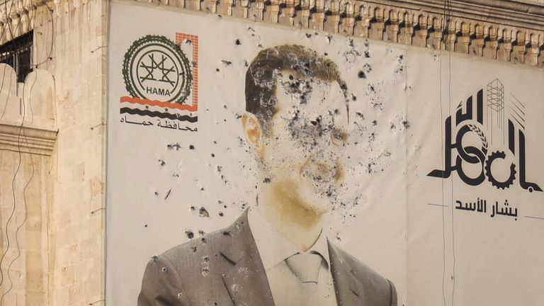 Syrian President Bashar al-Assad, riddled with bullets, in the aftermath of the opposition's takeover of Hama, Syria, Friday, Dec. 6, 2024. (Image Credit: Omar Albam / AP)