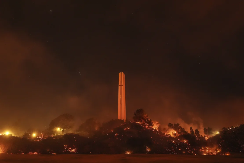 Malibu fire engulfs around the Phillips Theme Tower at Pepperdine University. (Image Credit: Jae C. Hong / AP)