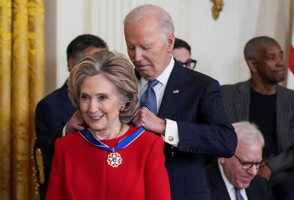 Who Are The Presidential Medal of Freedom Recipients 2025? 4 President Joe Biden presents the Presidential Medal of Freedom to former Secretary of State Hillary Clinton in the East Room of the White House, in Washington, D.C., Jan. 4, 2025. (Image Credit: Ken Cedeno / Reuters)