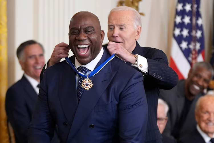 Who Are The Presidential Medal of Freedom Recipients 2025? 6 President Joe Biden presents the Presidential Medal of Freedom to basketball legend Earvin "Magic" Johnson in the East Room of the White House, Jan. 4, 2025, in Washington, D.C. (Image Credit: Manuel Balce Ceneta/AP)