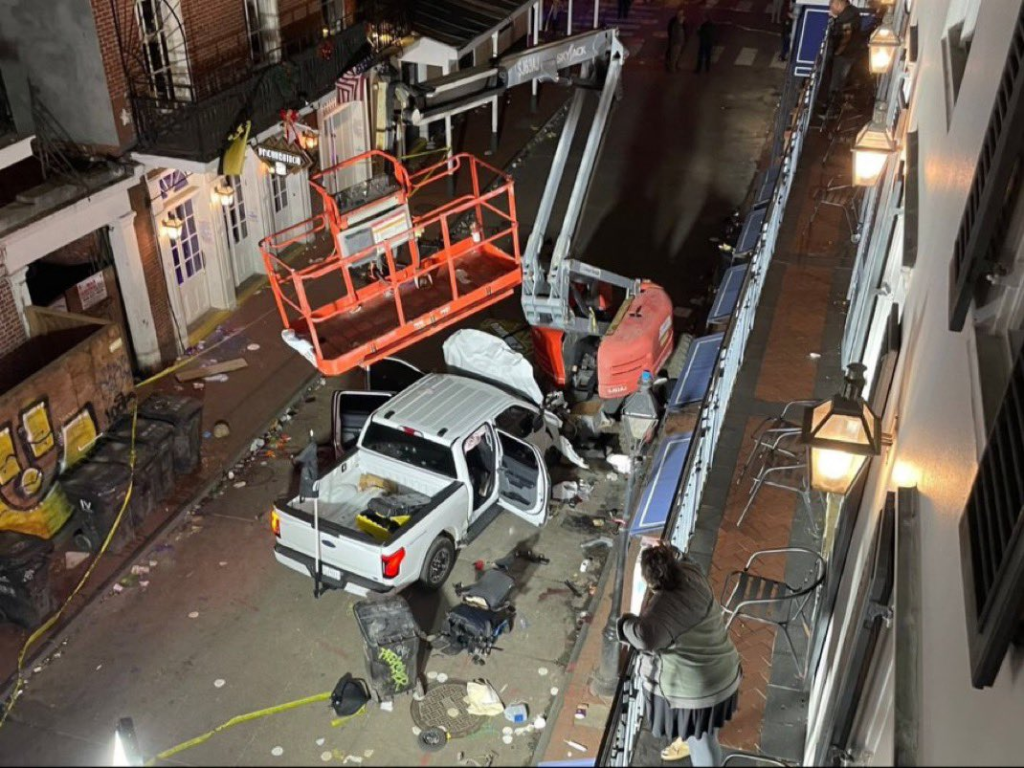 New Orleans Terror Attack: What Happened and Who Was Behind It? 1 The scene of the terror attack after a vehicle drove into a crowd earlier on Canal and Bourbon Street in New Orleans, Wednesday, Jan. 1, 2025. (Image Credit: Gerald Herbert / AP)
