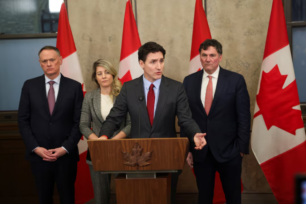 Trudeau's Tariff Response: Retaliatory on U.S. Imports 1 Prime Minister Justin Trudeau's press conference is joined by Finance Minister Dominic LeBlanc, Minister of Foreign Affairs Melanie Joly, and Minister of Public Safety David McGuinty, as Justin Trudeau response to U.S. President Donald Trump's orders to impose 25% tariffs on Canadian imports on February 1, 2025. (Image Credit: REUTERS)