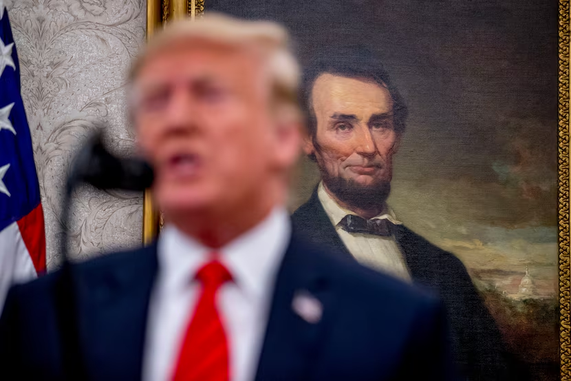 Trump's Road To Unites Americans on Presidents' Day 2025 2 A painting of Abraham Lincoln is seen behind President Donald Trump. (Image Credit: Andrew Harnik / AP)