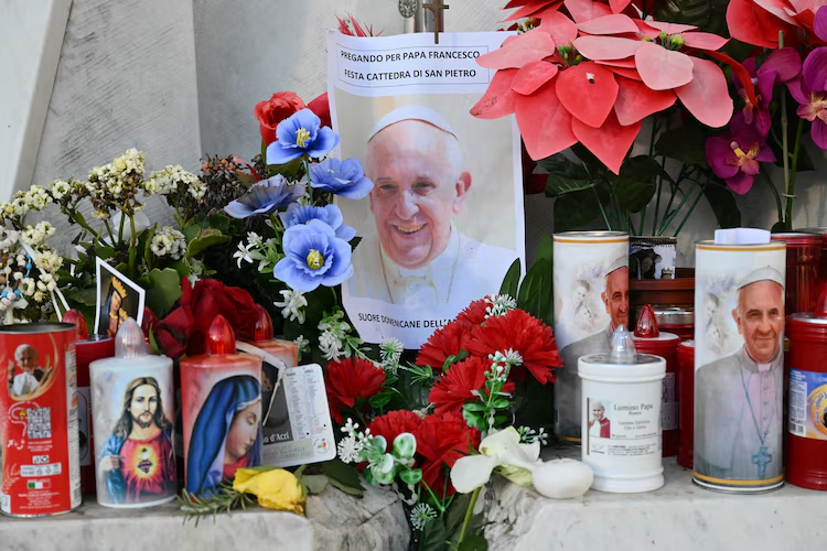 Pope Francis in Critical Condition: Latest Health Update 3 Supports for Pope Francis are laid at the statue of John Paul II outside the Gemelli hospital where Pope Francis is hospitalized in Rome on Feb. 22, 2025. (Image Credit: Alberto Pizzoli / AFP)
