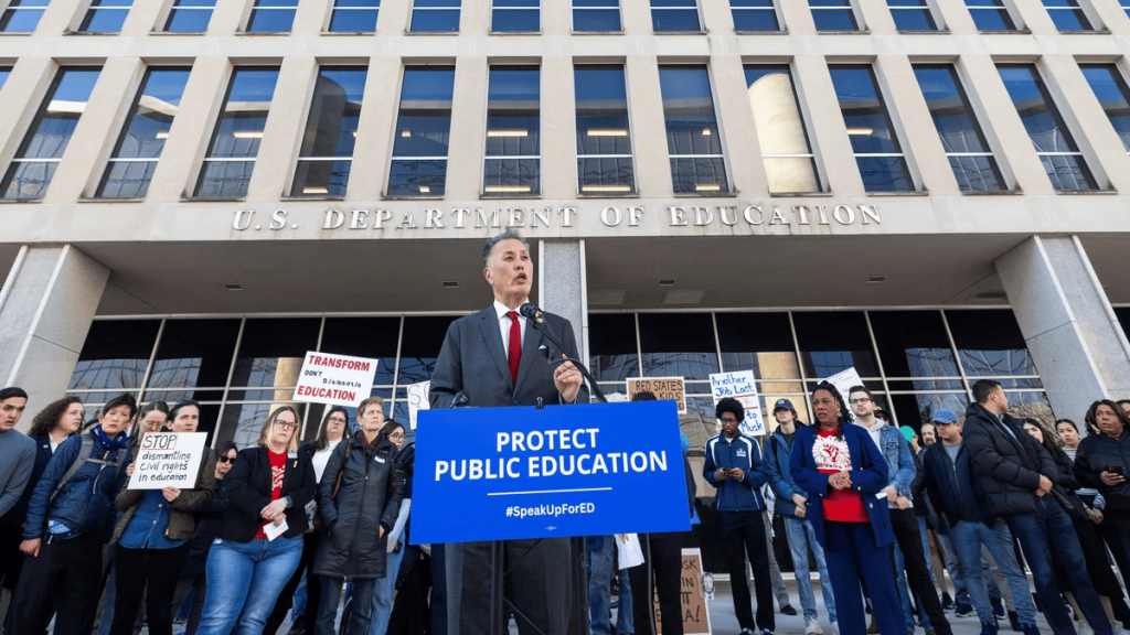 California RepresentativeMark Takano with civil servants and supporters to protest the Department of Education layoffs in Washington DC on Tuesday. (Image Credit: Jim Lo Scalzo / EPA)