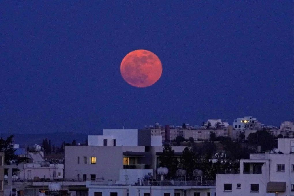 How To Watch The Blood Moon Eclipse Tonight? 1 The blood moon rises over the Cypriot capital Nicosia on May 26, 2021. (Image Credit: AFP)