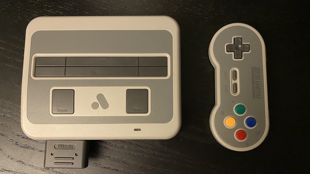 Analogue Unveils Super Nt Plus and Mega Sg Plus With Wireless and USB-C Analogue Super Nt Plus console with wireless controller on a desk
