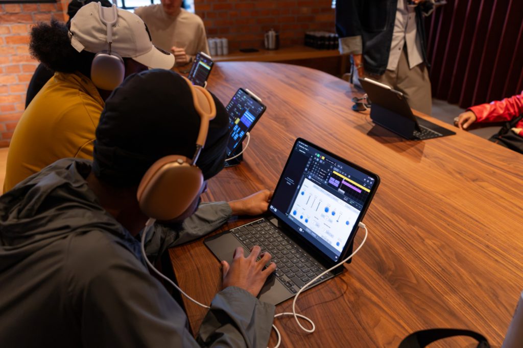 Students work on Apple devices in a classroom setting as part of the Apple x King’s Trust Creative Labs.