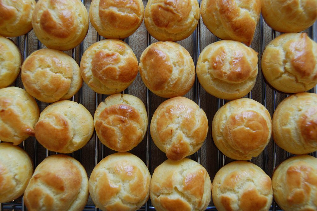 Chocolate and Pumpkin Spice Choux Buns Recipe Chocolate pumpkin spice choux buns with craquelin topping on a plate