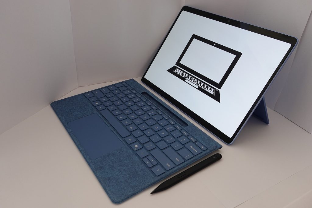 Empty classroom desk with a tablet and glasses