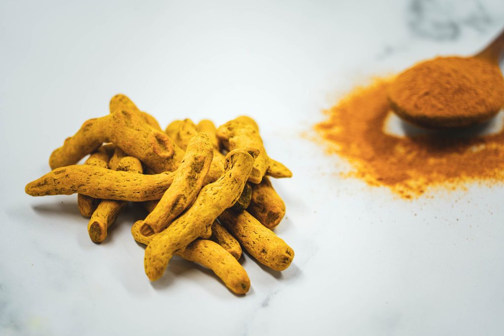 Curcumin Shows Most Balanced Cancer Cell Impact in New Study Curcumin powder and turmeric root on a laboratory table for curcumin cancer study