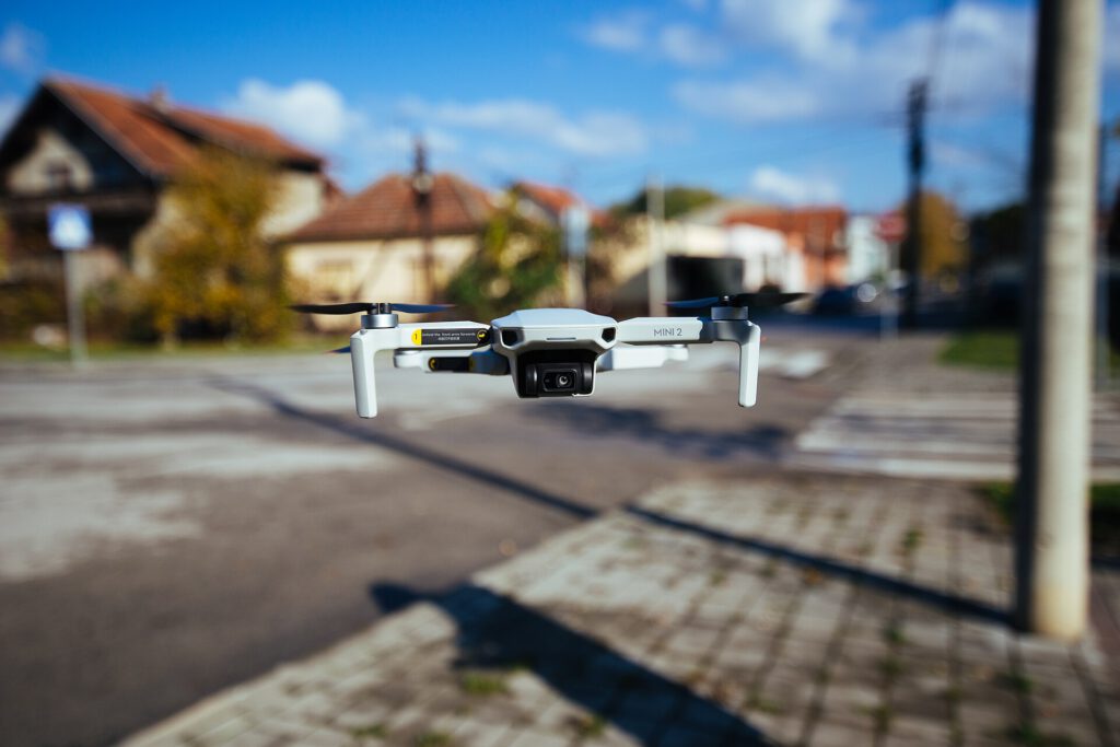 The Buzz of Delivery: Drones Face Noise Backlash A drone flying over a suburban neighborhood causing noise complaints