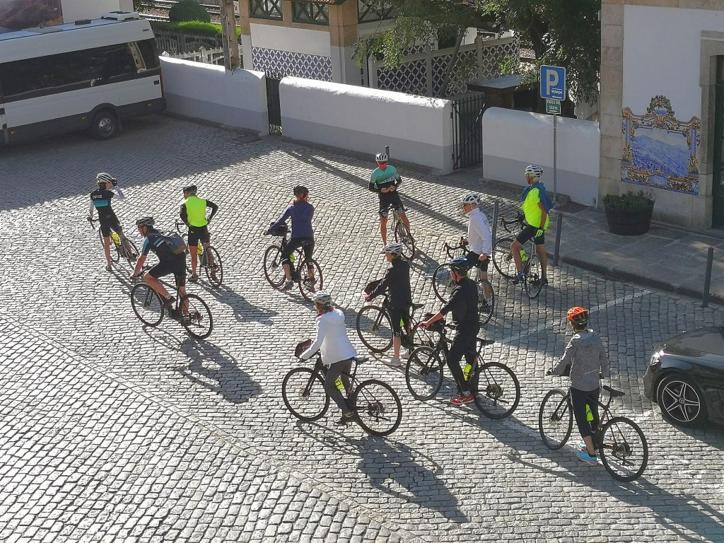 Cyclists riding through a vineyard in Burgundy during DuVine Cycling tour