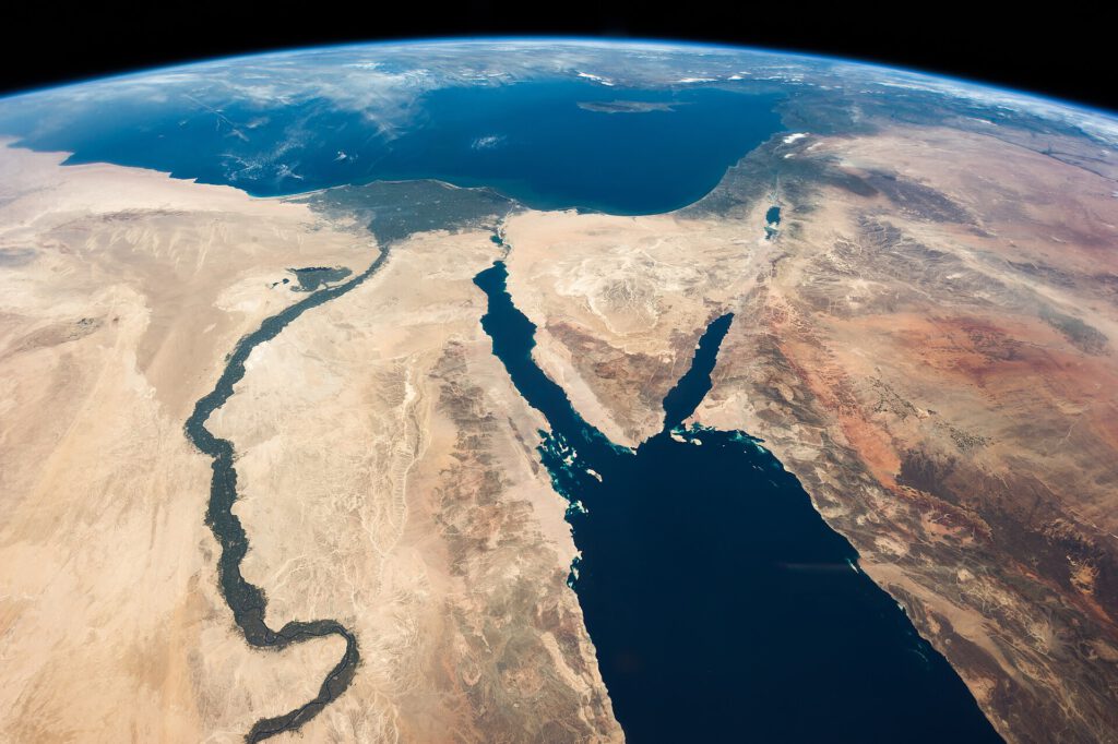 Luxury Nile cruise ship sailing past ancient Egyptian temples