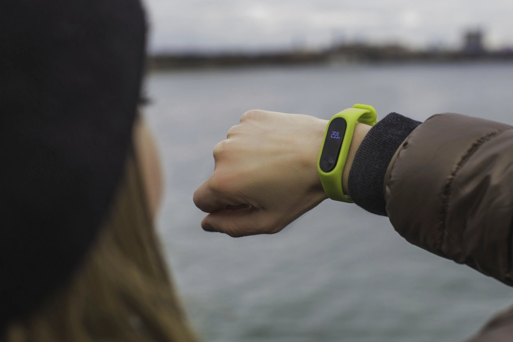 Fitbit Edge Lacks NFC, Google Cites Low Usage 2 woman checking her fitness tracker