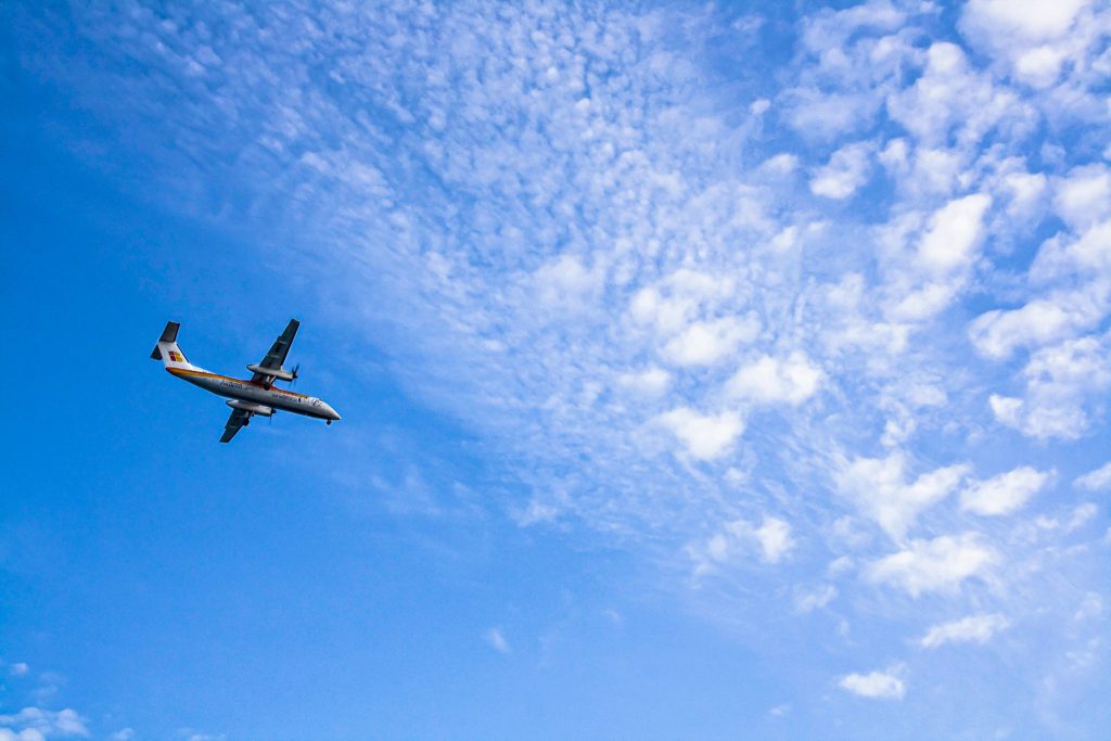 Flapping Airplanes Raises $1B at $6B Valuation 3 A plane flying on a blue cloudy sky.