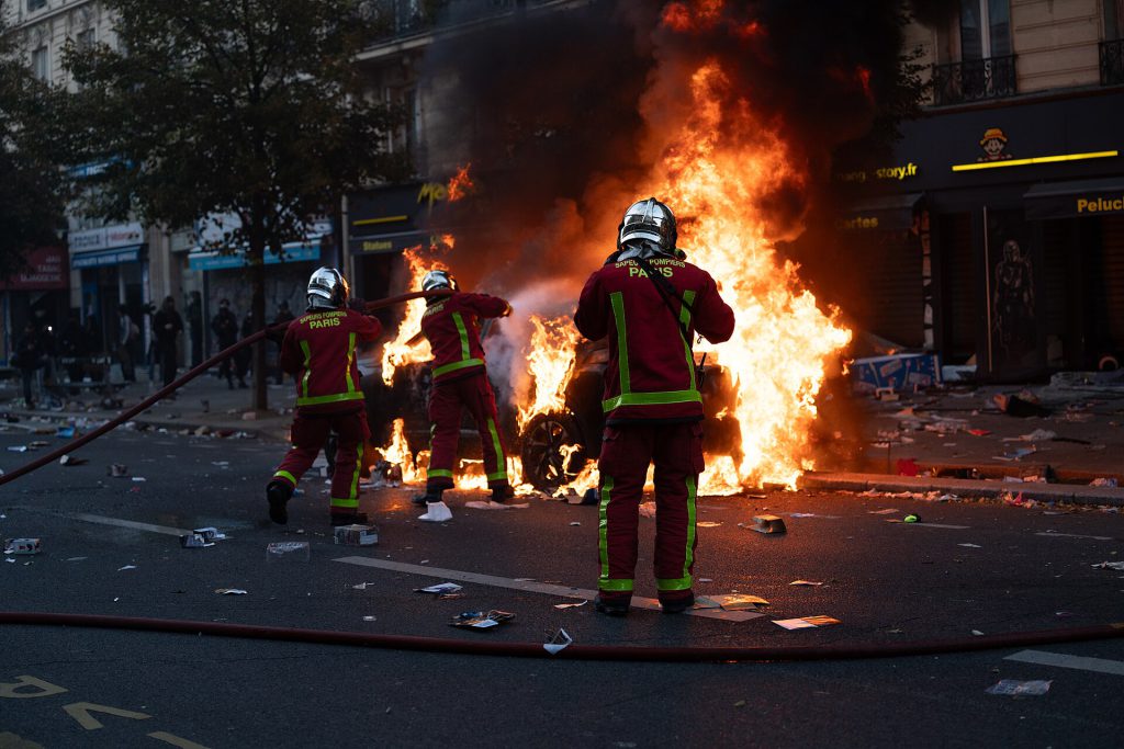French Government in Crisis After Record Violence 1 Paris riots, 17 October 2026 Firefighters extinguishing a burning car JJxFile